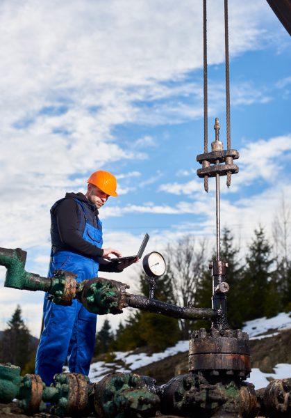 Engineer using observing a deep well injection in oil field.